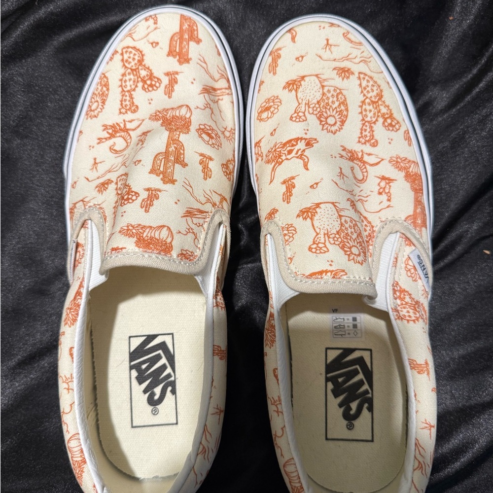 Vans Cream and Orange Slip-On Sneakers with Whimsical Design.